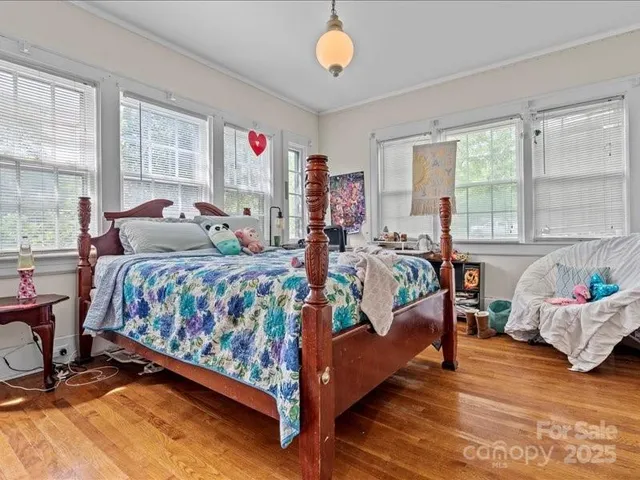 a bedroom with bed and window