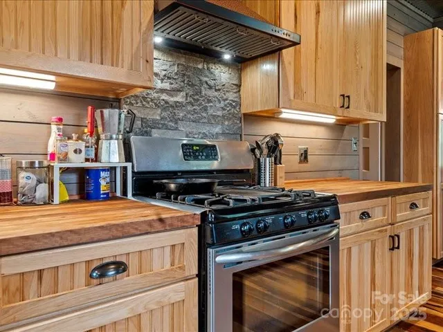a kitchen with stainless steel appliances granite countertop a stove and a cabinets