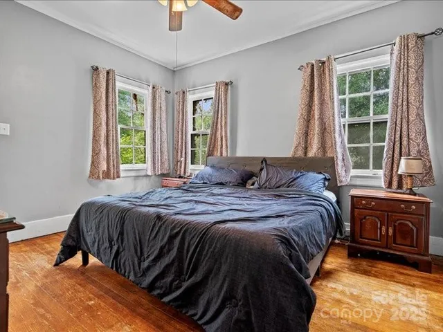 a bedroom with a bed and a large window