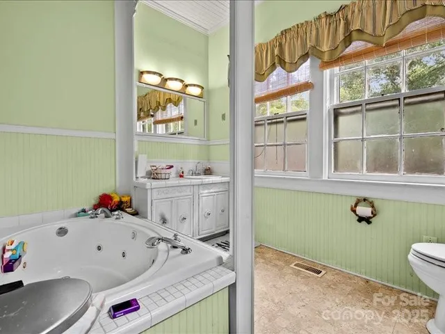 a bathroom with a sink mirror and toilet