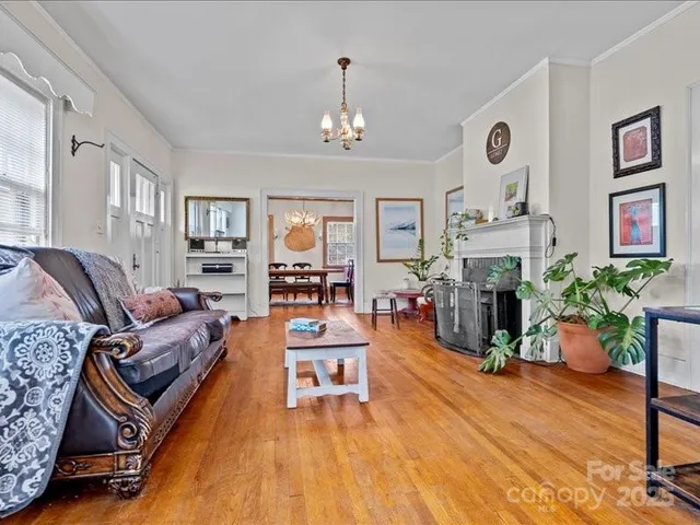a living room with furniture fireplace and wooden floor