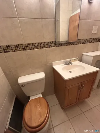 a bathroom with a sink a toilet and mirror