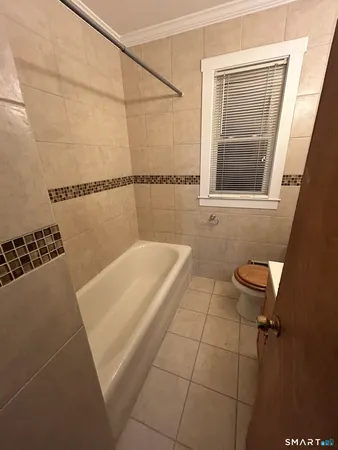 a bathroom with a bathtub and shower