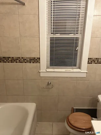a bathroom with a toilet a sink and bathtub
