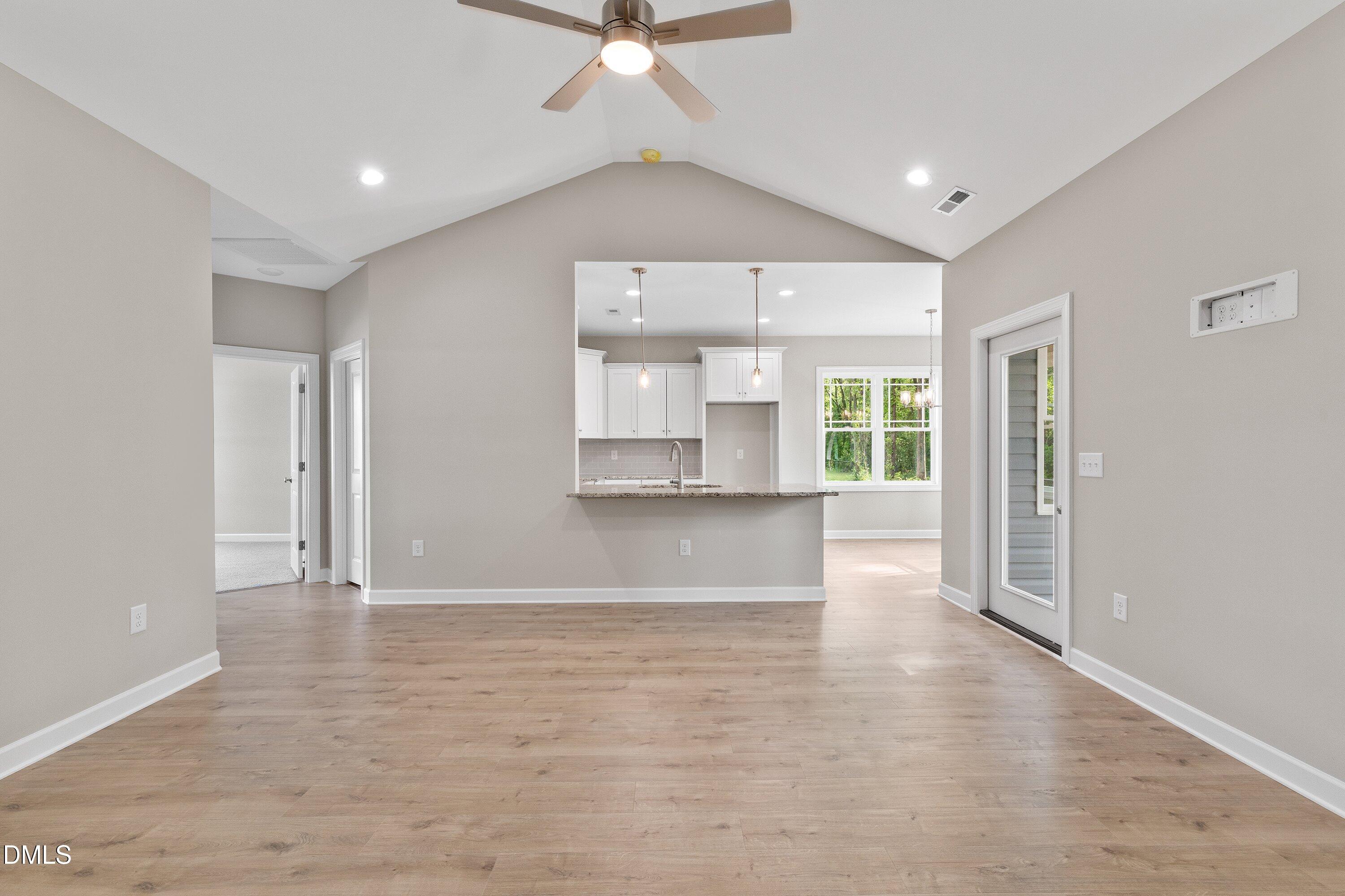 1115 Nor-Am Road Pikeville, NC 27863 - Photo 10 of 40 an empty room with wooden floor and windows