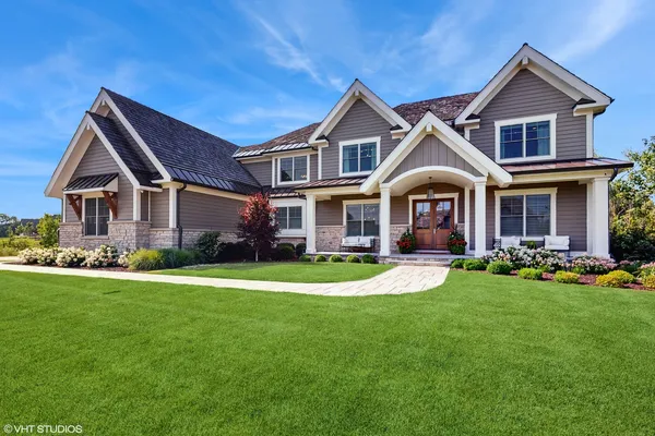a front view of a brick house with a yard