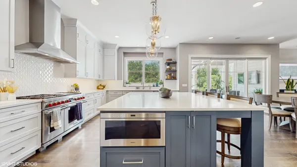 a kitchen with stainless steel appliances granite countertop a stove and more cabinets