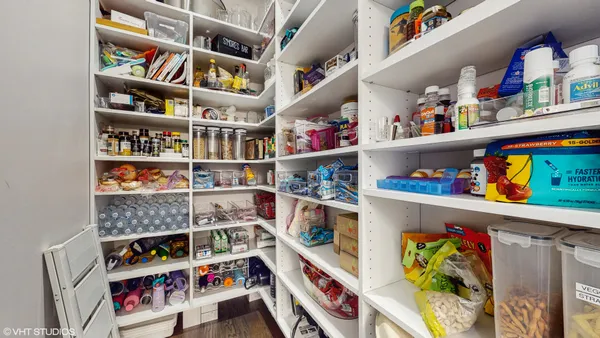 a living room with furniture and paintings on the wall