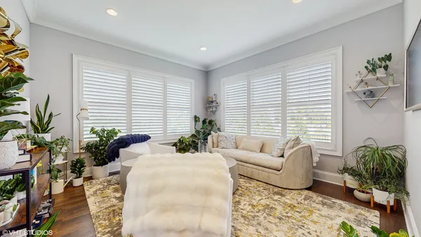 a bedroom with furniture and wooden floor