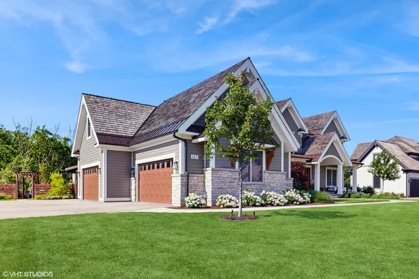 a front view of a house with a garden