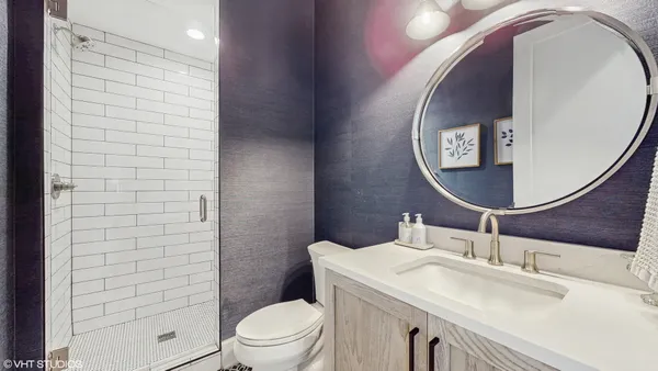 a bathroom with a sink toilet and mirror