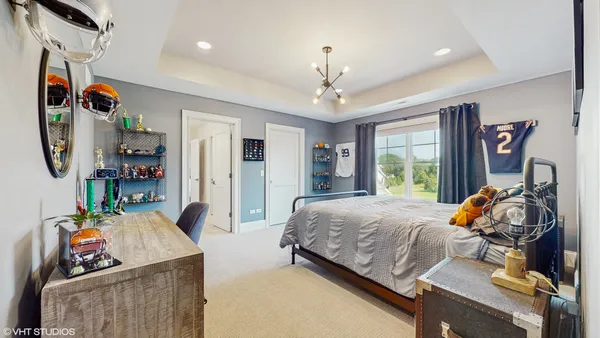 a bedroom with a bed and a chandelier