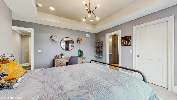 a bedroom with a bed and a large window