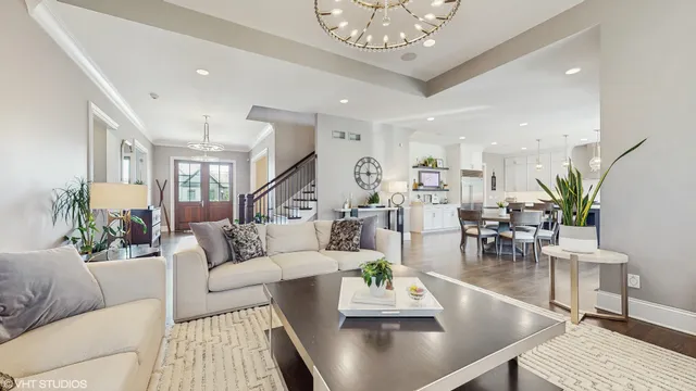 a living room with furniture wooden floor and a chandelier