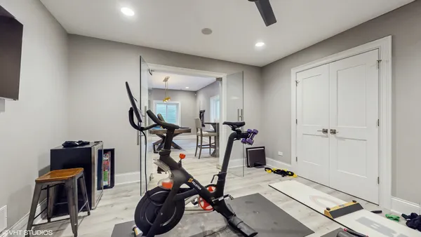 a living room with furniture a flat screen tv and a table