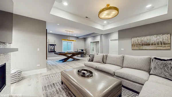 a dining room with stainless steel appliances a table chairs and a book shelf
