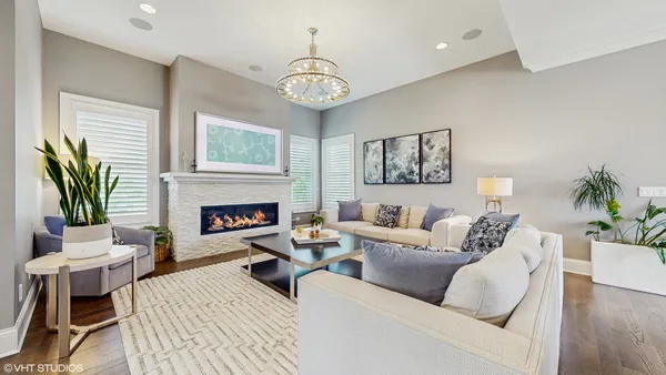 a living room with furniture a fireplace and a table
