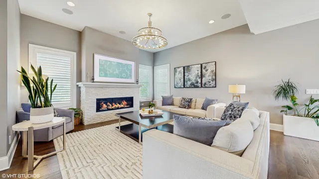 a living room with furniture a fireplace and a table