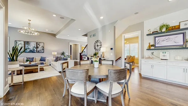 a view of a dining room with furniture kitchen and wooden floor