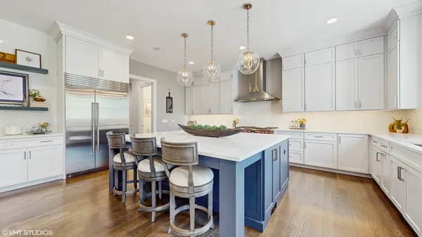 a kitchen with kitchen island granite countertop a sink a center island and cabinets