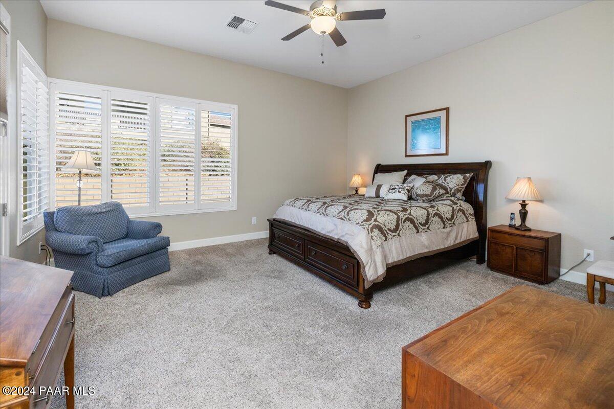 1478 Range View Circle Prescott Valley, AZ 86314 - Photo 11 of 31 a spacious bedroom with a bed and a couch