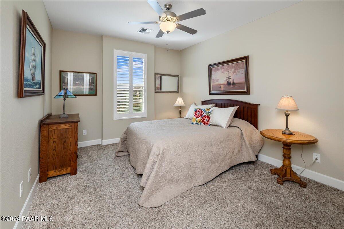 1478 Range View Circle Prescott Valley, AZ 86314 - Photo 13 of 31 a bedroom with a bed and a chandelier