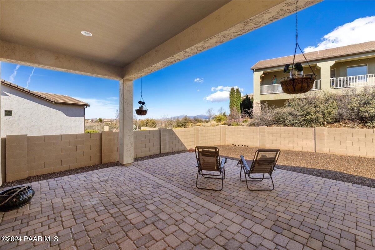 1478 Range View Circle Prescott Valley, AZ 86314 - Photo 18 of 31 a patio with a table and chairs and potted plants