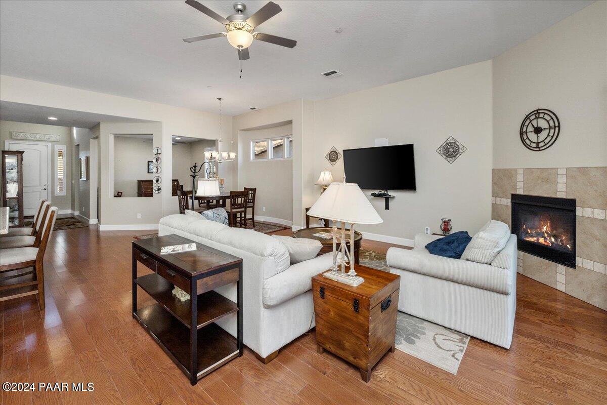 1478 Range View Circle Prescott Valley, AZ 86314 - Photo 2 of 31 a living room with furniture a fireplace and a flat screen tv