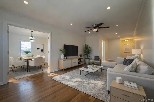 a living room with furniture a flat screen tv and a table