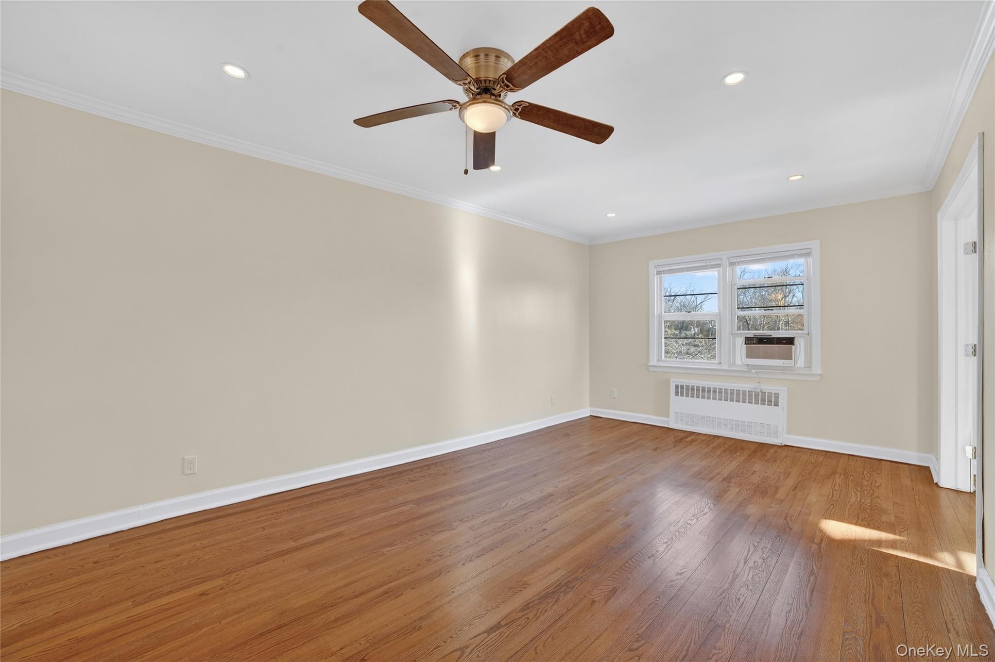 2 S Road, Unit 2P Harrison, NY 10528 - Photo 11 of 35 a view of an empty room with wooden floor and a window