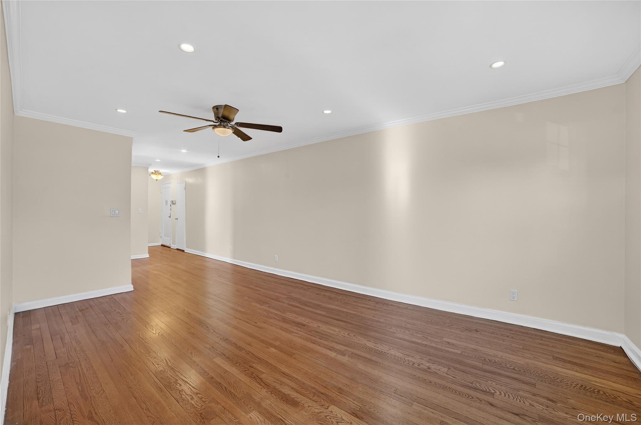 2 S Road, Unit 2P Harrison, NY 10528 - Photo 14 of 35 a view of an empty room with wooden floor and a ceiling fan