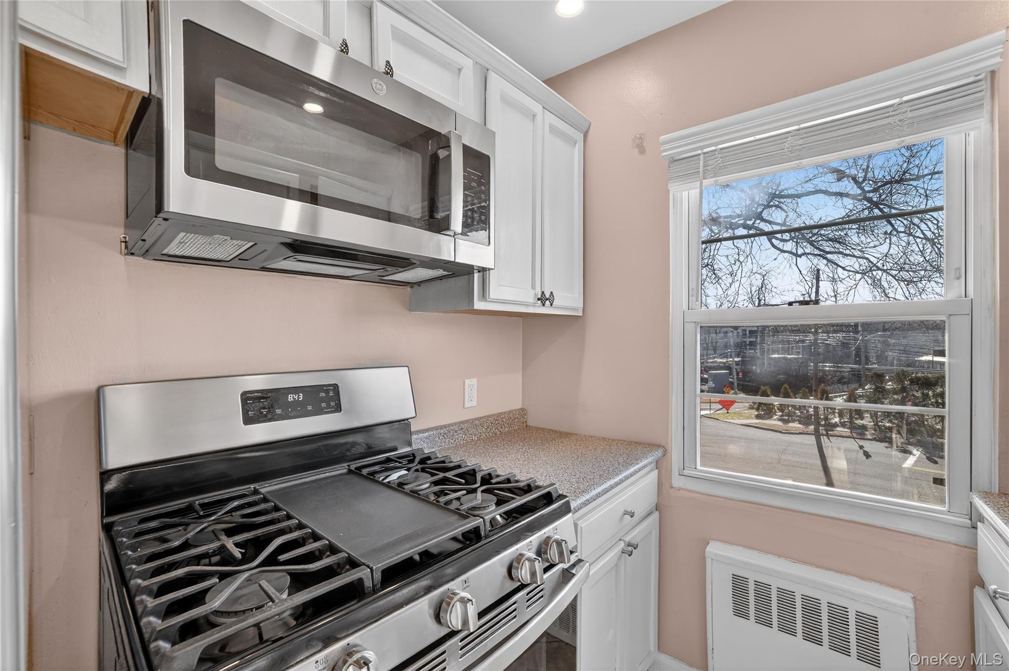 2 S Road, Unit 2P Harrison, NY 10528 - Photo 18 of 35 a kitchen with stainless steel appliances granite countertop a stove and a microwave