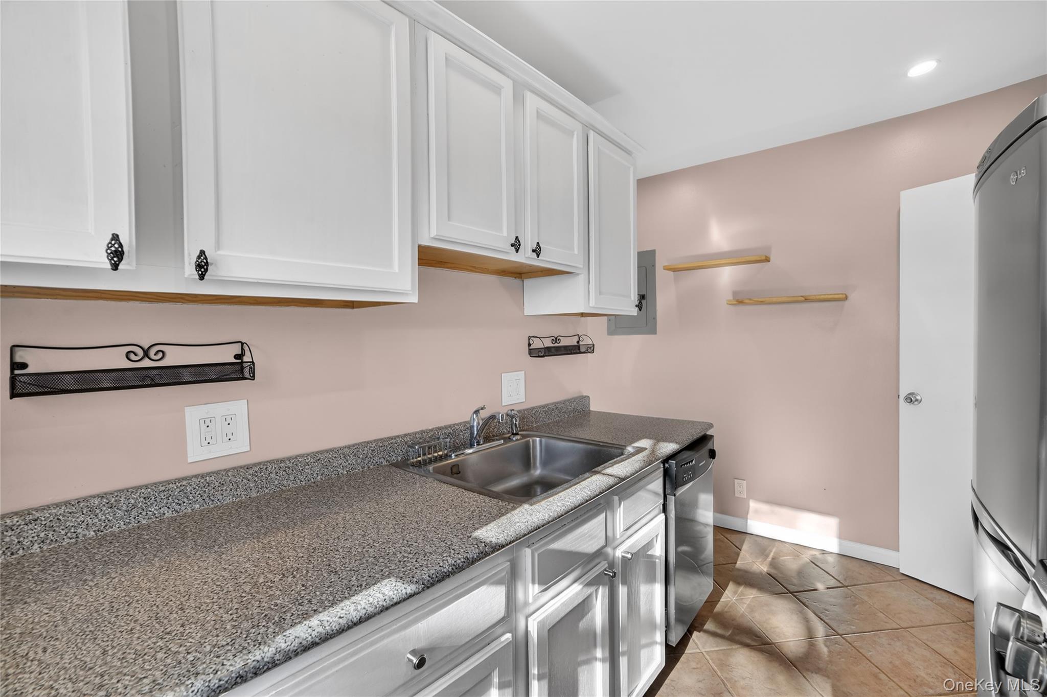 2 S Road, Unit 2P Harrison, NY 10528 - Photo 19 of 35 a kitchen with granite countertop white cabinets and a sink