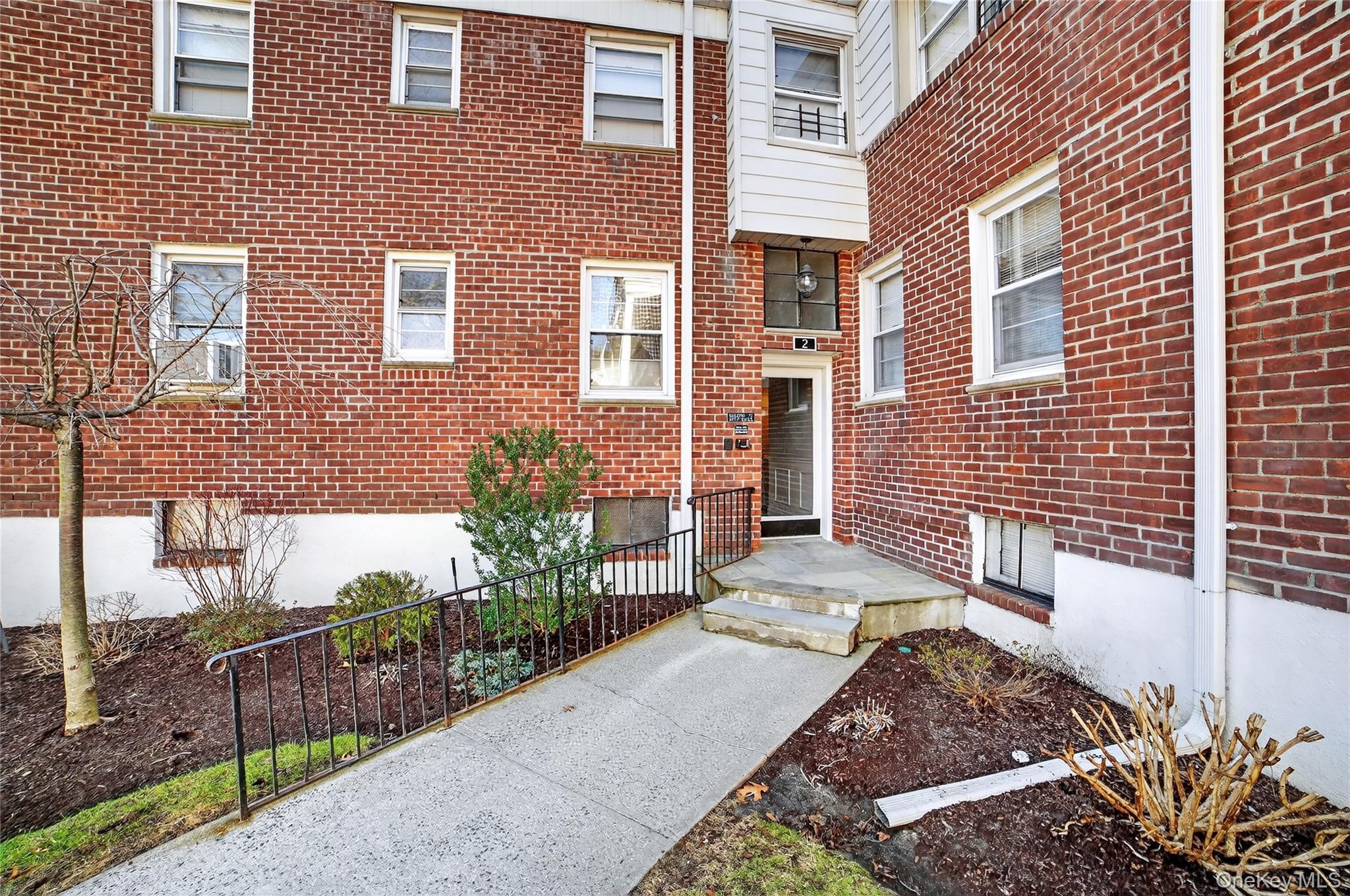 2 S Road, Unit 2P Harrison, NY 10528 - Photo 26 of 35 a view of a brick house with a yard