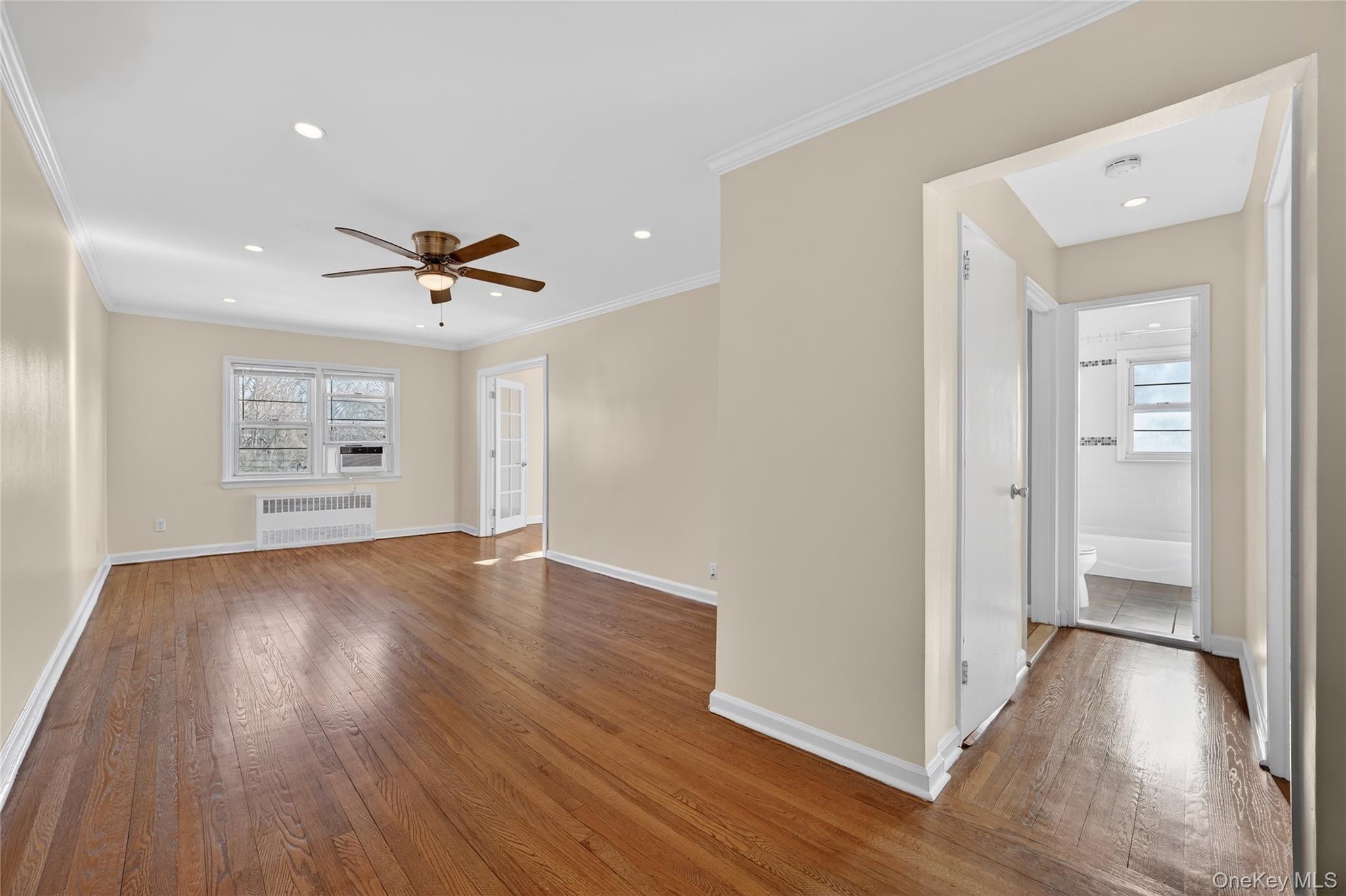 2 S Road, Unit 2P Harrison, NY 10528 - Photo 8 of 35 a view of an empty room with wooden floor and a window