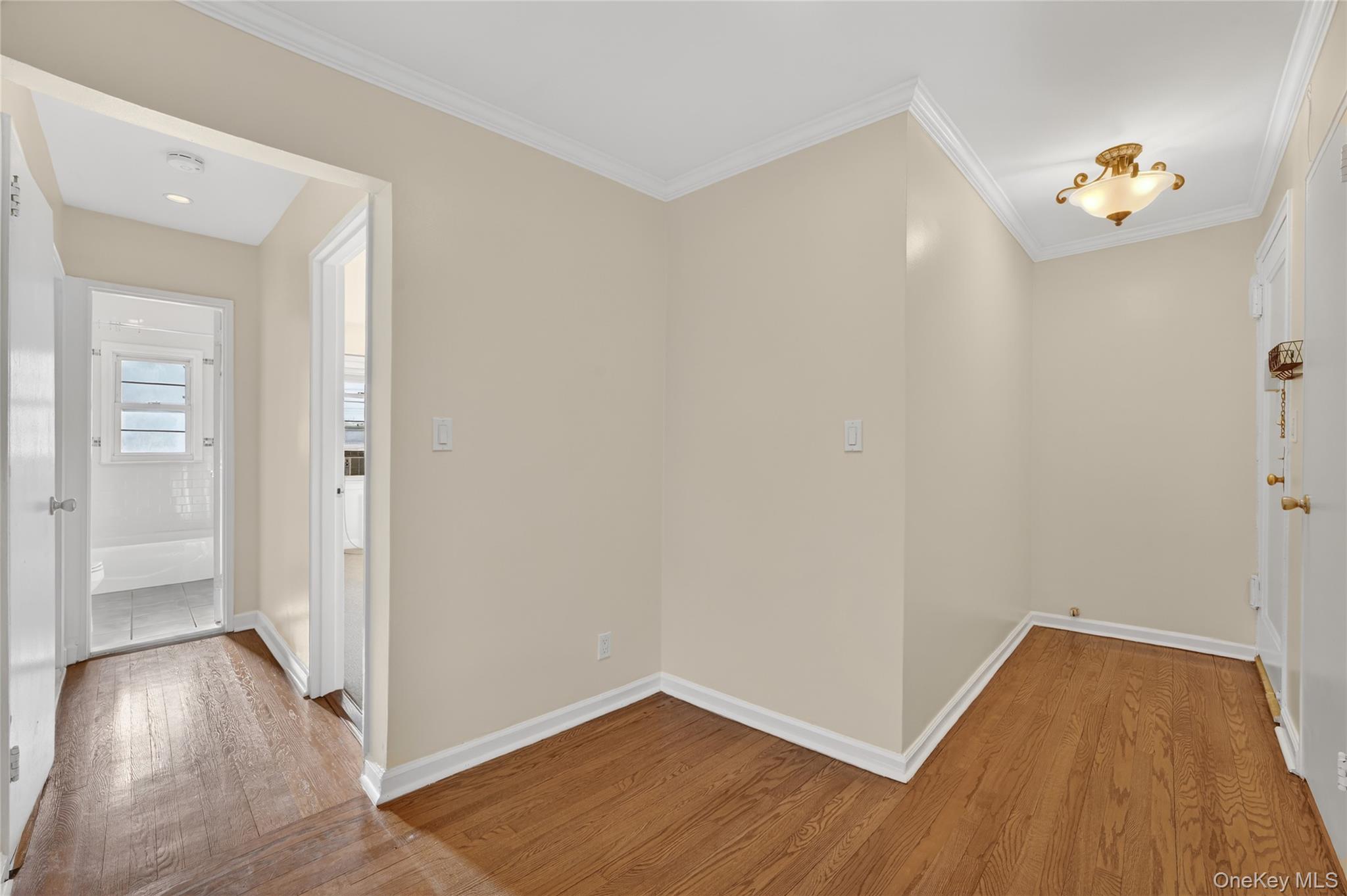 2 S Road, Unit 2P Harrison, NY 10528 - Photo 9 of 35 an empty room with wooden floor and hallway