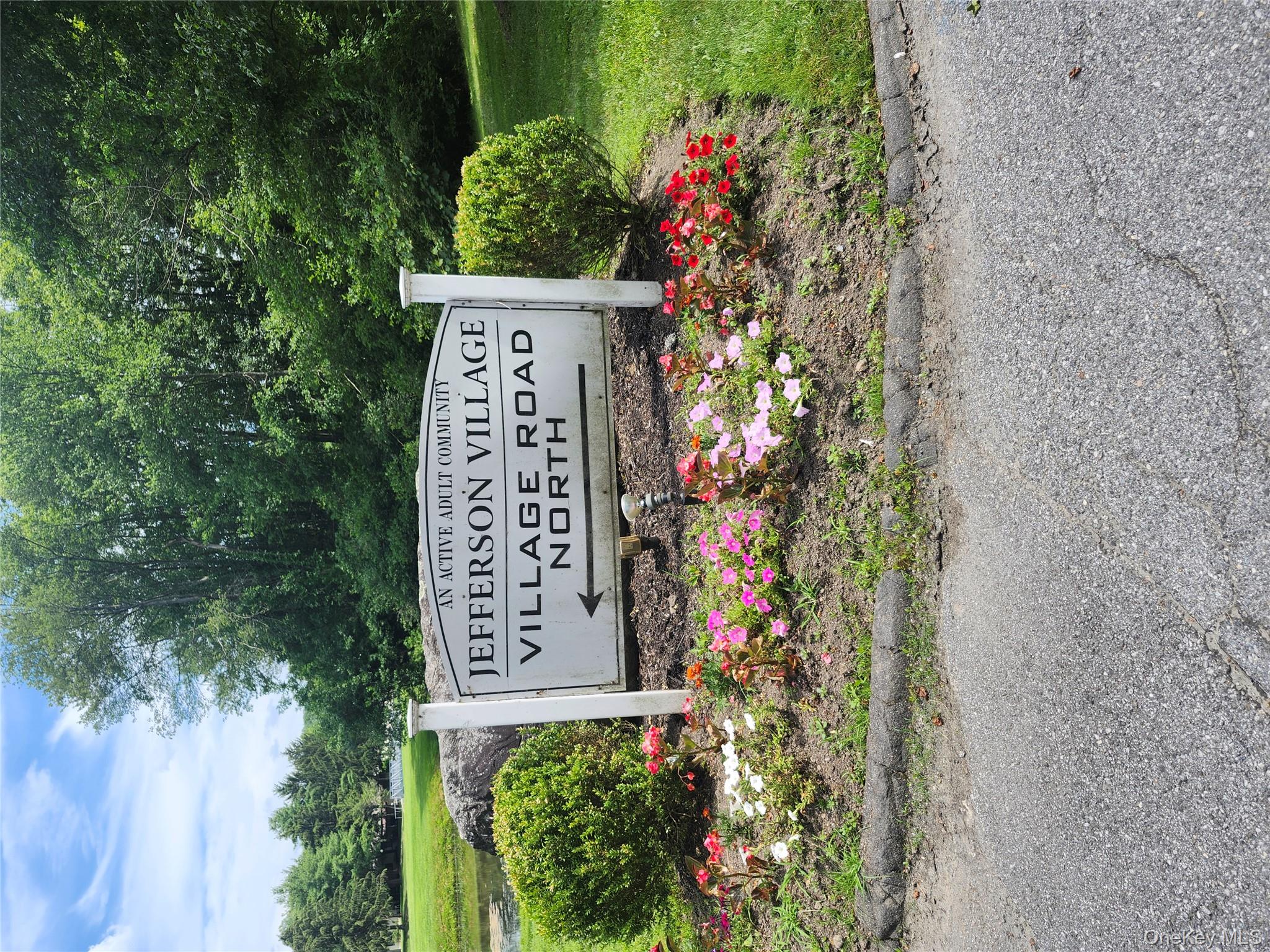 108 Village Road, Unit B Yorktown Heights, NY 10598 - Photo 14 of 42 a view of a sign board with yard