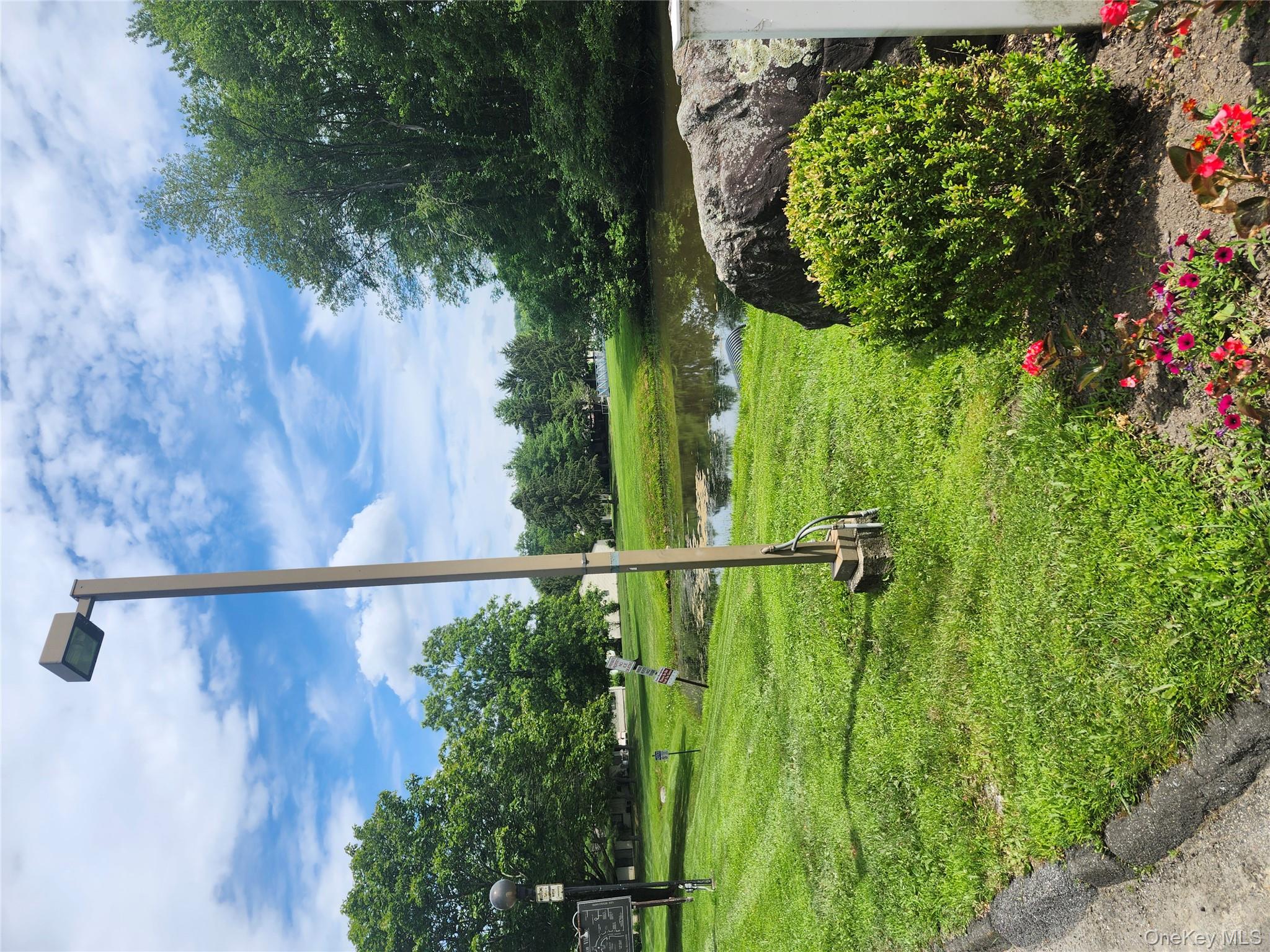 108 Village Road, Unit B Yorktown Heights, NY 10598 - Photo 15 of 42 a view of a garden with a lake