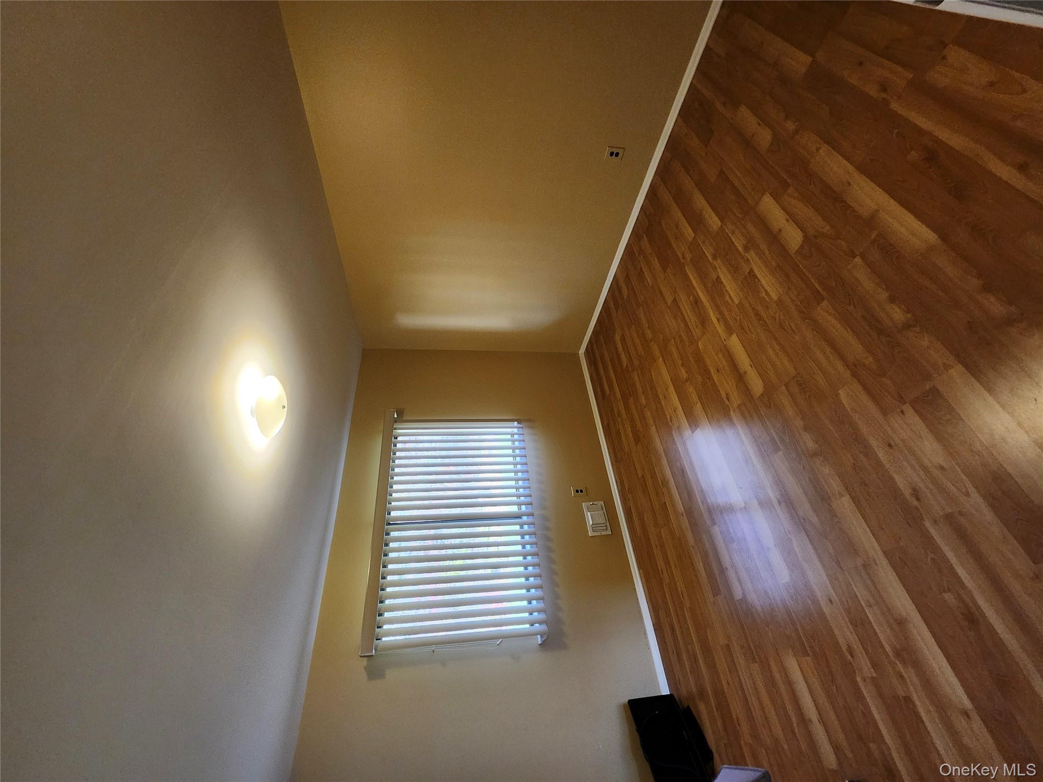 108 Village Road, Unit B Yorktown Heights, NY 10598 - Photo 30 of 42 an empty room with wooden floor and windows