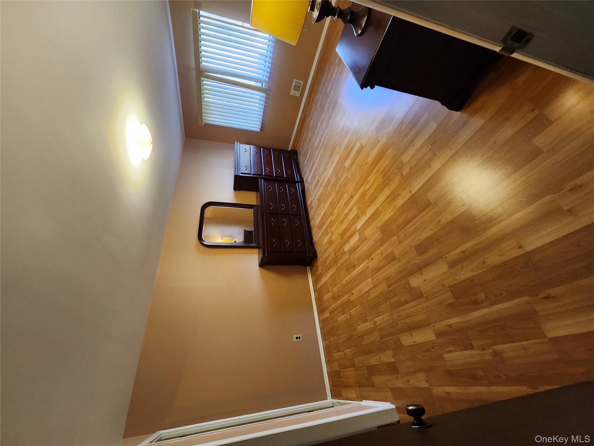 108 Village Road, Unit B Yorktown Heights, NY 10598 - Photo 34 of 42 a spacious bedroom with a bed and wooden floor