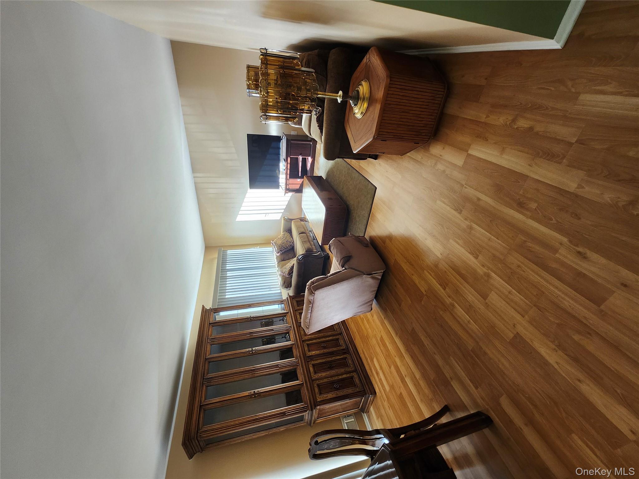 108 Village Road, Unit B Yorktown Heights, NY 10598 - Photo 37 of 42 Living area featuring wood finished floors and baseboards