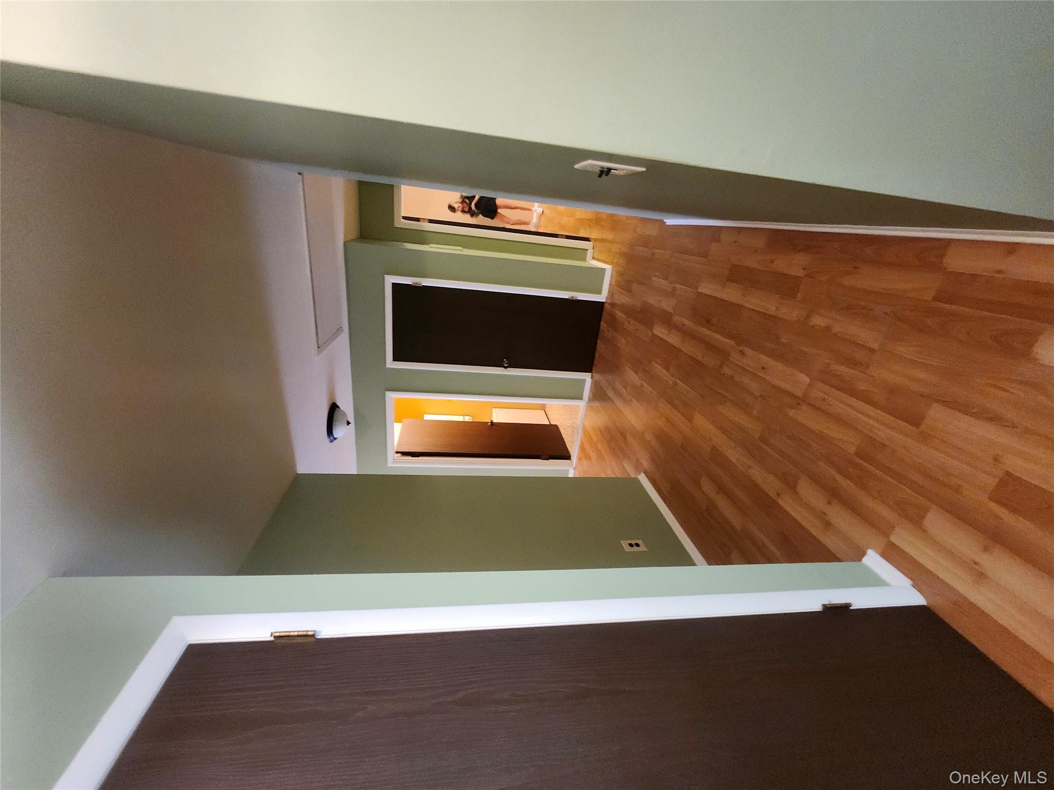 108 Village Road, Unit B Yorktown Heights, NY 10598 - Photo 5 of 42 a view of a hallway with wooden floor and closet