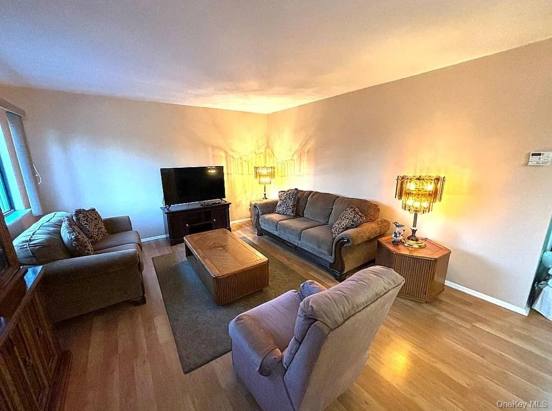 108 Village Road, Unit B Yorktown Heights, NY 10598 - Photo 6 of 42 a living room with furniture and a flat screen tv