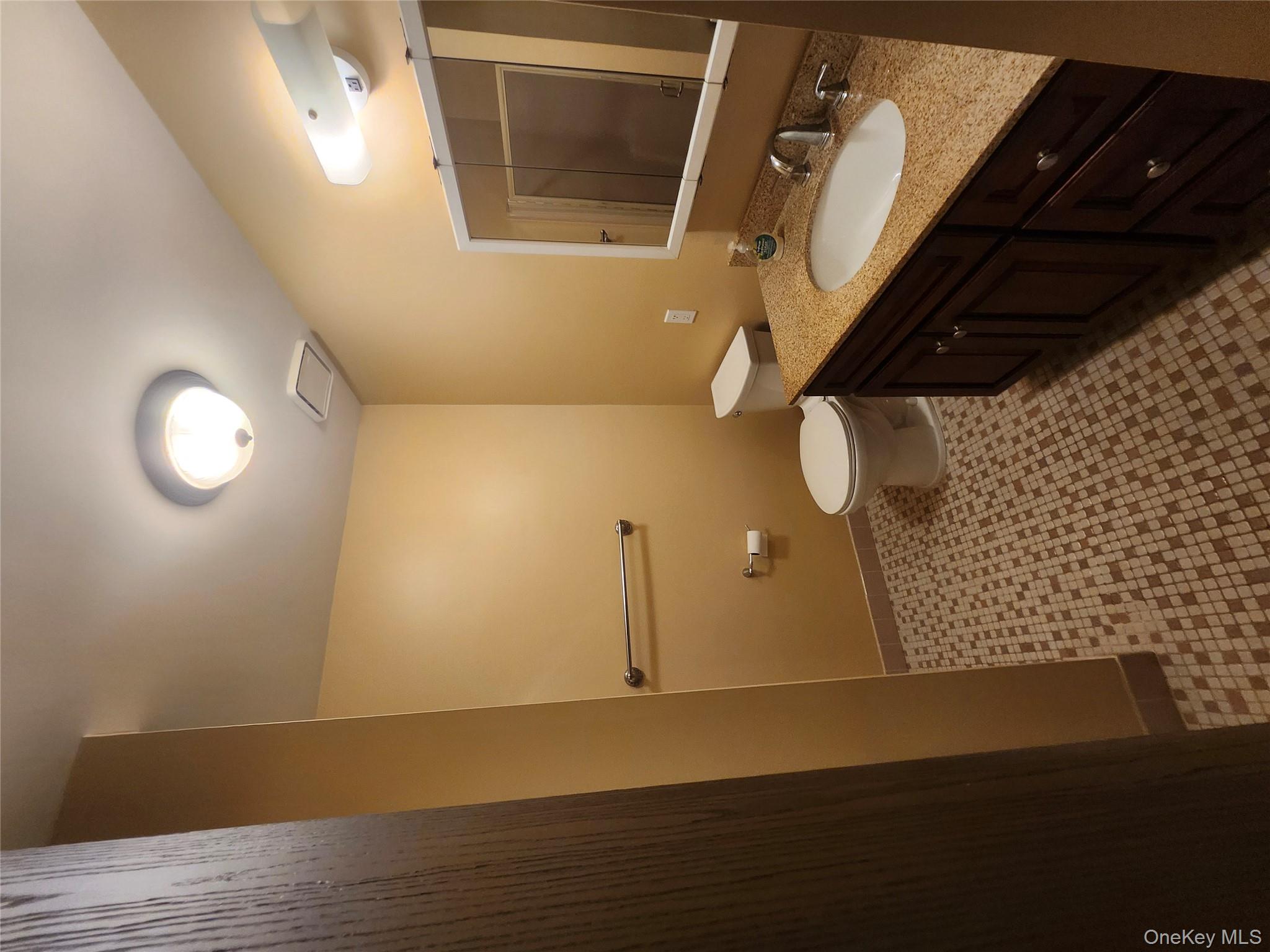 108 Village Road, Unit B Yorktown Heights, NY 10598 - Photo 8 of 42 a bathroom with a double vanity sink toilet and a mirror