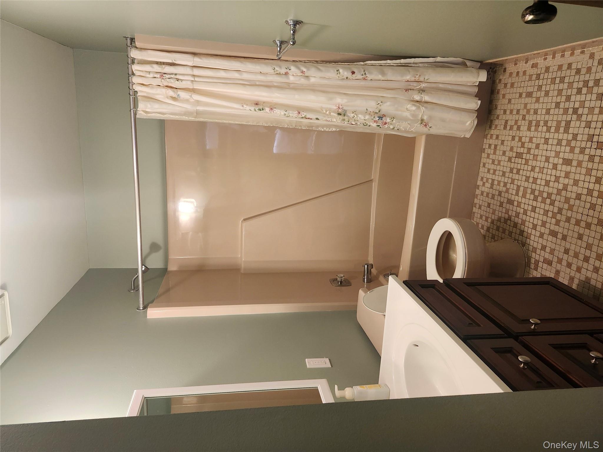108 Village Road, Unit B Yorktown Heights, NY 10598 - Photo 9 of 42 a bathroom with a sink a toilet a mirror and shower
