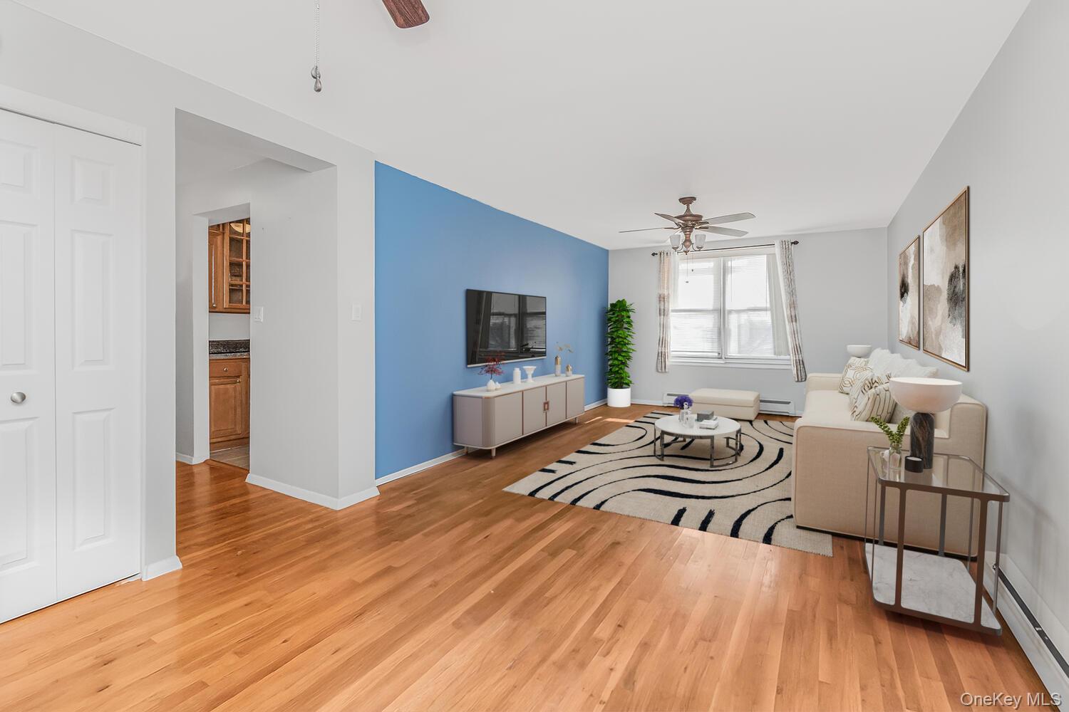 1110 Stadium Avenue, Unit 5F Bronx, NY 10465 - Photo 2 of 20 a living room with furniture and a flat screen tv