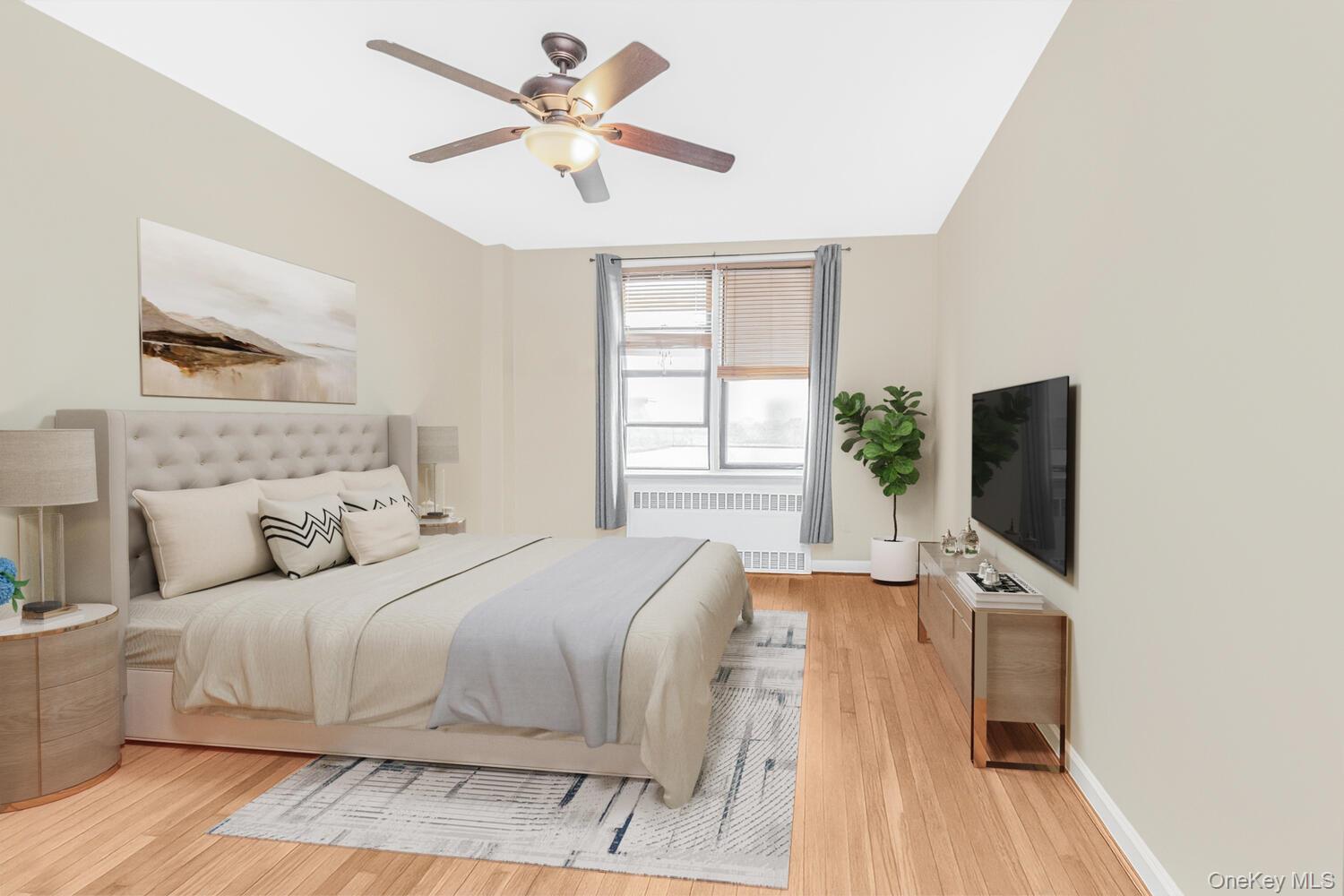 1110 Stadium Avenue, Unit 5F Bronx, NY 10465 - Photo 7 of 20 a bedroom with a large bed a flat tv screen and a dresser