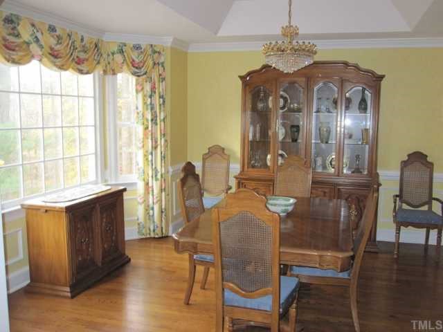 5616 North Hawthorne Way Raleigh, NC 27613 - Photo 3 of 12 Formal dining with bay window, hardwood floors, moldings and trey ceiling