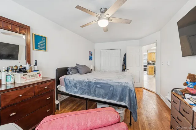a bedroom with a bed and a wooden floor
