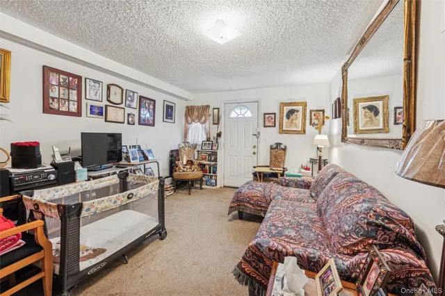 a bedroom with furniture and a flat screen tv